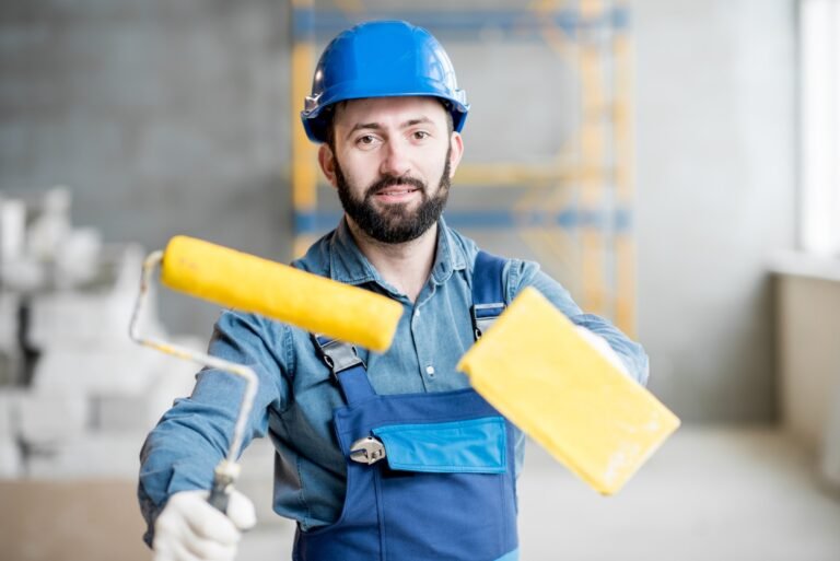 Builder with paint roll indoors